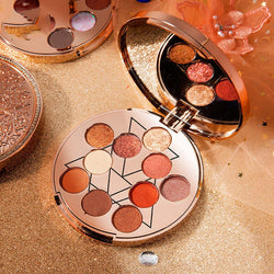 Goddess Of Luck 10-color waterproof eye shadow palette with shimmering and matte shades on a decorative background.