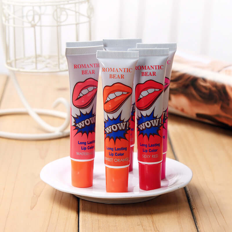 Color-Fast Tear-Off Lip Gloss in Sweet Orange, Watermelon Red, and Sexy Red on a plate.