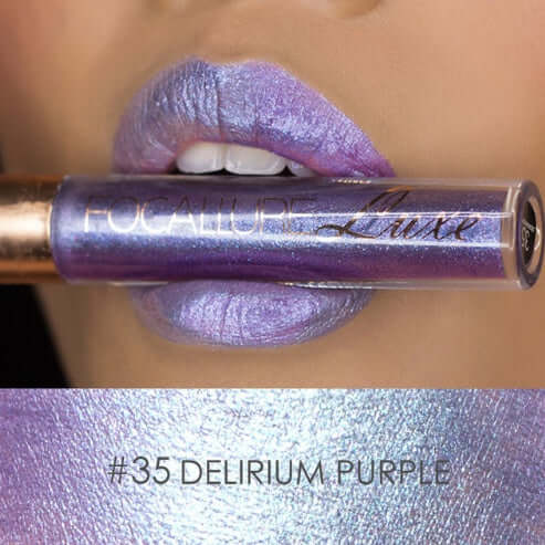 Focallure Luxe Delirium Purple lip gloss tube held above shimmering purple lips, showcasing its unique color and shine.