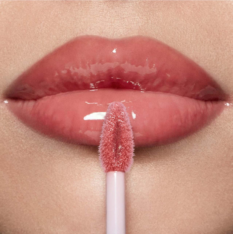 Close-up of lips applying PHOFAY Hyaluronic Lip Gloss, showcasing its moisturizing and shiny finish.