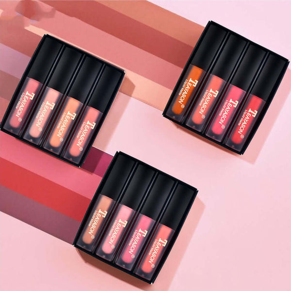 Lip gloss set of four liquid matte shades in elegant packaging on a gradient background.