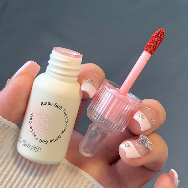 Bottle Mirror Lip Gloss in hand, showcasing applicator and colorful gloss, part of the Dudu small feeding bottle series.