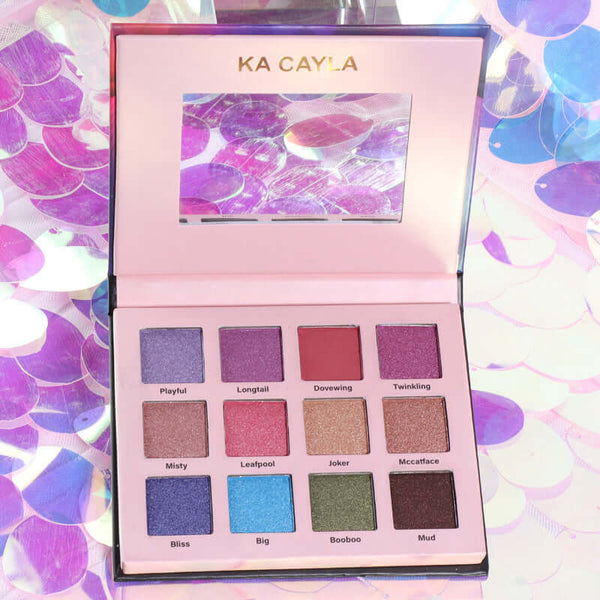 Fashion Creative 12 Color Eye Shadow Palette showcasing vibrant shades such as Playful, Longtail, and Twinkling on a shimmering background.