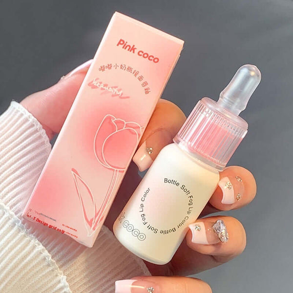 Bottle Mirror Lip Gloss in Pink Coco with pastel packaging and dropper, ideal for moisturizing and softening lips.