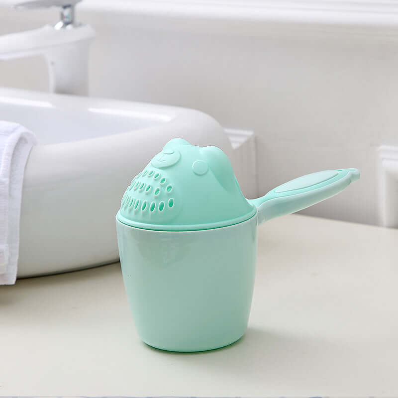 Baby shampoo cup in light green, designed for children 6 months and older, ideal for a hassle-free bath time experience.
