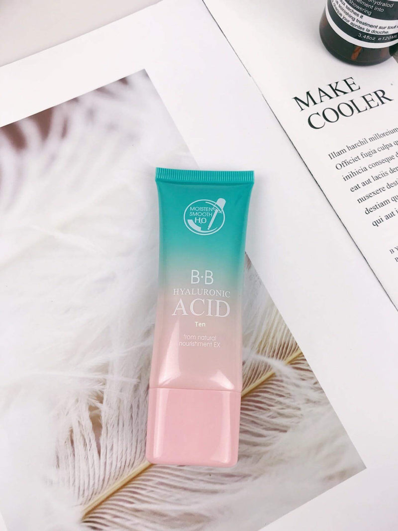 BB cream with hyaluronic acid in a teal and pink tube, placed on a magazine, part of a moisturizing skincare set.