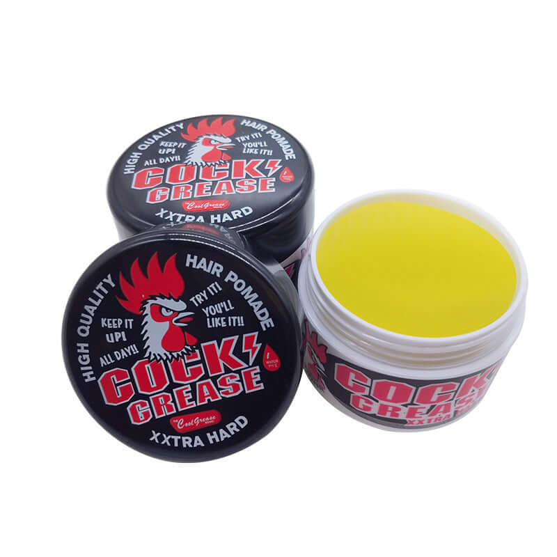 Big Cock Grease hair pomade jars with yellow paste, showcasing strong hold for stylish looks.