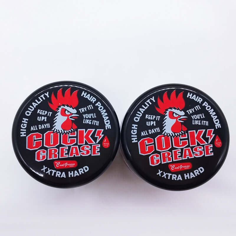 Cock Grease hair pomade jars featuring bold rooster logo and text, designed for high-quality styling.