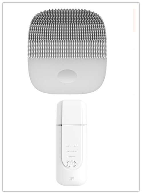 White facial cleansing device set featuring a textured brush and a portable mist sprayer for skin care.