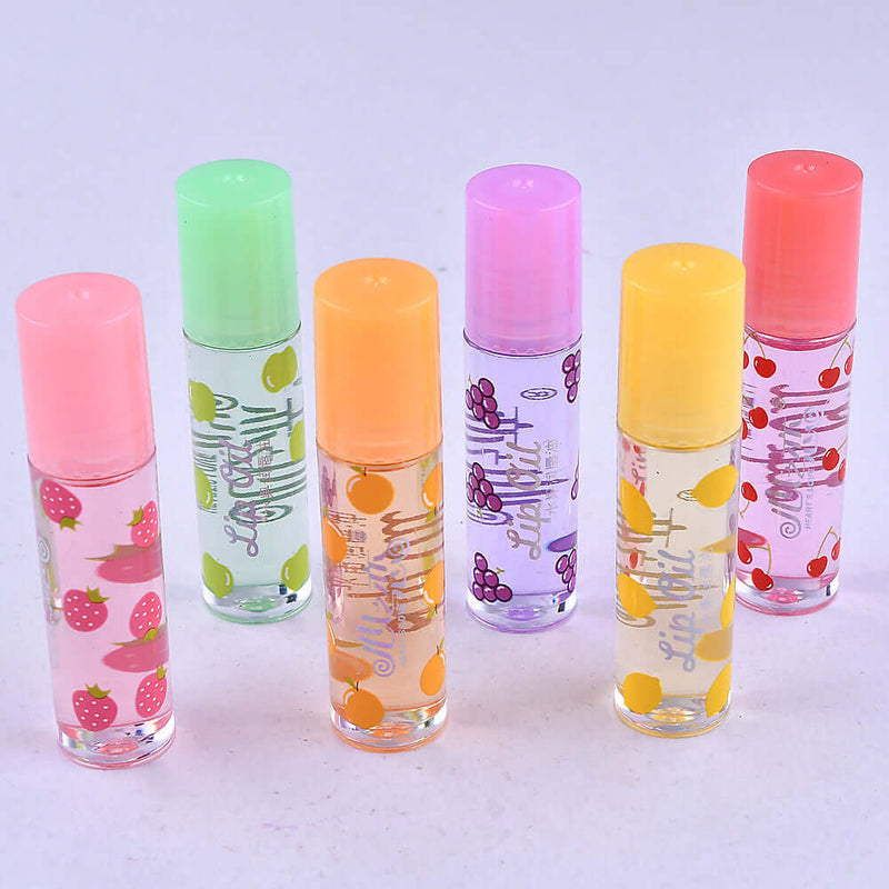 Colorful variety of transparent lip glosses in tubes with fruity designs, perfect for moisturizing and adding shine to lips.