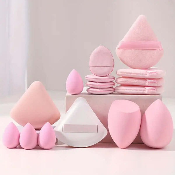 Pink cosmetic egg makeup set including various beauty sponges and powder puffs for face wash and skin care.