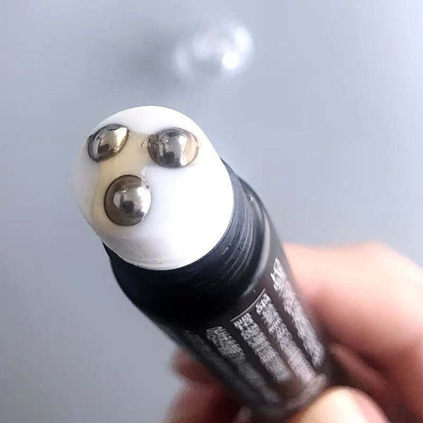 Close-up of Ginger Ball Hair Treatment Essential Oil applicator with three metallic massage balls for scalp care.