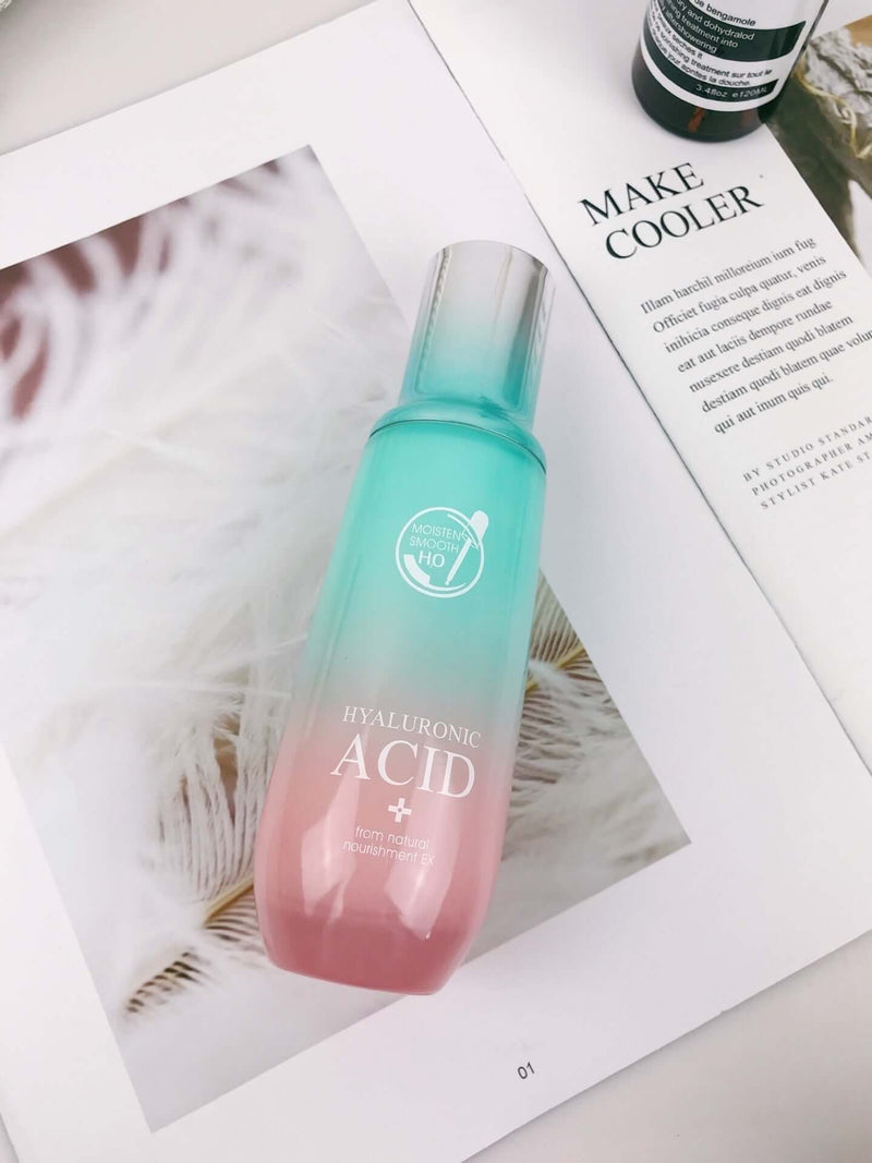 Hyaluronic Acid moisturizing facial care product in a pink and teal bottle on a magazine.