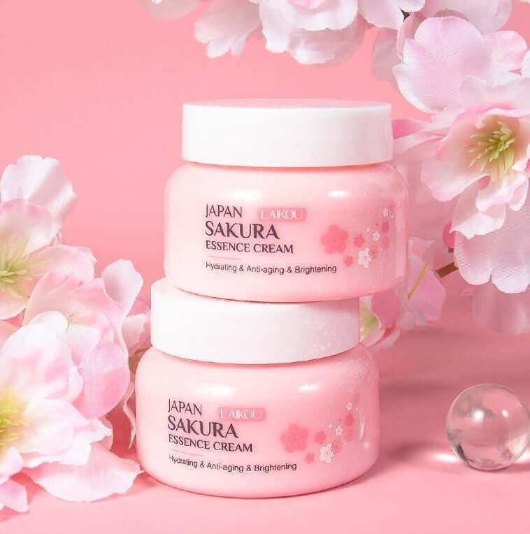 Sakura Essence Cream jars on a floral background, promoting hydration, anti-aging, and brightening benefits.