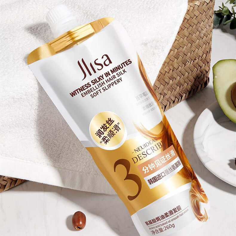 Jlisa Embellish Hair Silk treatment tube, designed for soft, silky hair, placed on a natural background with avocado.