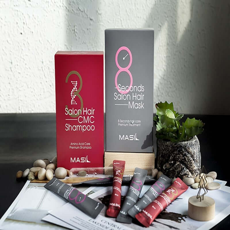 Maslan 8 Second Hair Mask and Salon Hair CMC Shampoo on a table, showcasing premium hair care products.