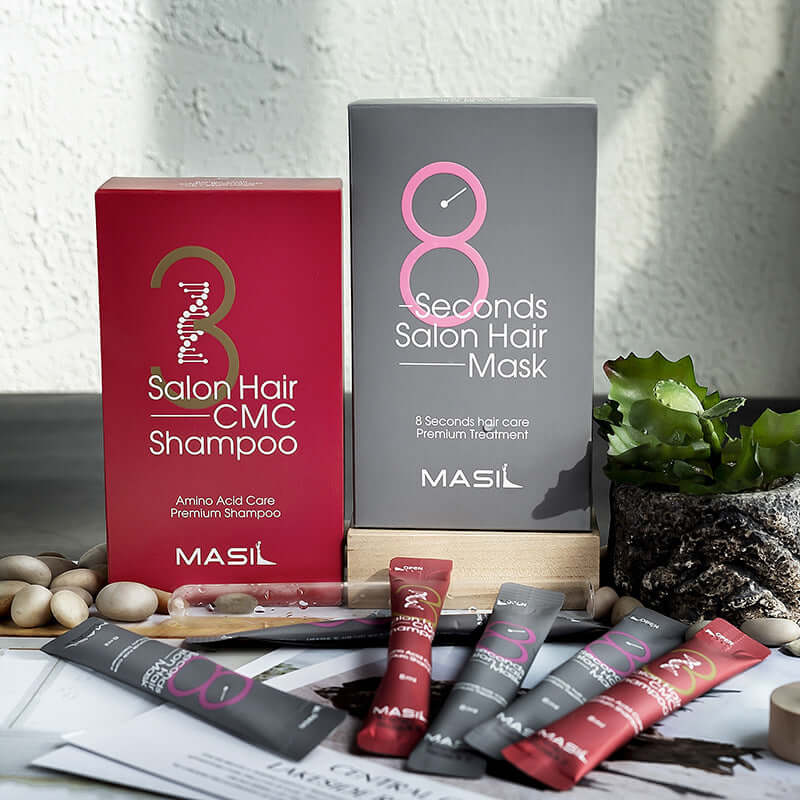 Maslan 8 Second Hair Mask and Salon Hair CMC Shampoo displayed together with treatment sachets on a wooden surface.