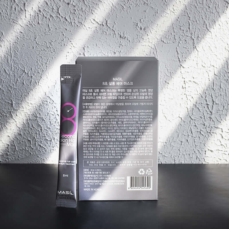 Maslan 8 second hair mask sachet and box on textured background, highlighting fast hair treatment benefits.