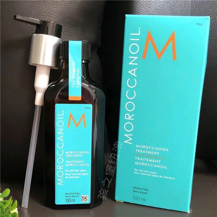 Moroccan hair oil treatment in a brown bottle with an attached syringe dispenser and turquoise packaging.