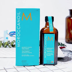 Moroccanoil treatment bottle and box for all hair types, promoting soft, healthy hair.