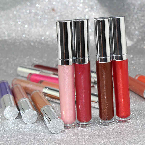 Pearl lip gloss clear lip oil in round tubes, showcasing various shades for moisturizing and toning lips.