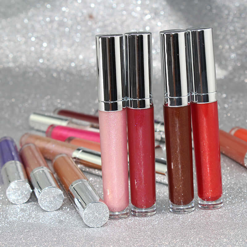 Pearl lip gloss clear lip oil in round tubes, showcasing various shades for moisturizing and toning lips.