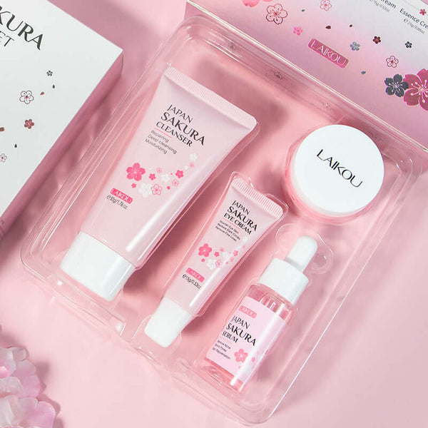 Sakura Skin Care Set showcasing cleansing, eye cream, essence, and face cream in pink packaging.