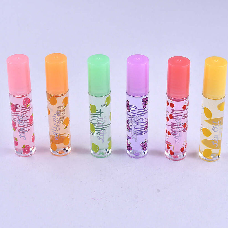 Six colorful rollerball lip gloss tubes in fruity flavors with playful designs on transparent packaging.
