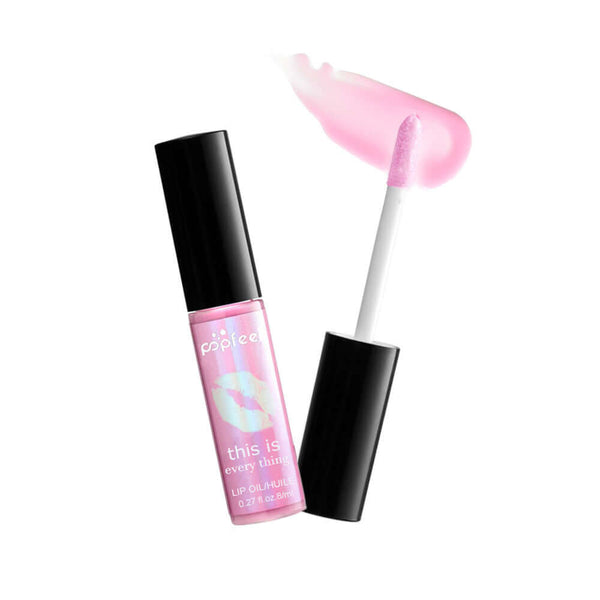 Transparent lip gloss with a shiny finish, packaged in a sleek tube, enriched with vitamins for nourishment.