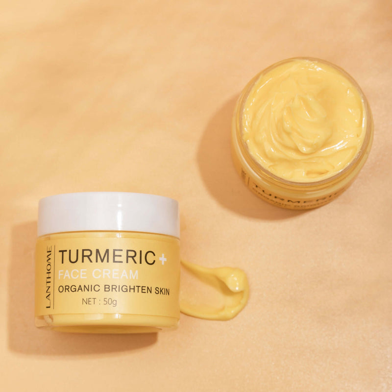 Turmeric essential oil face cream in a jar with a creamy texture, promoting bright and revitalized skin.